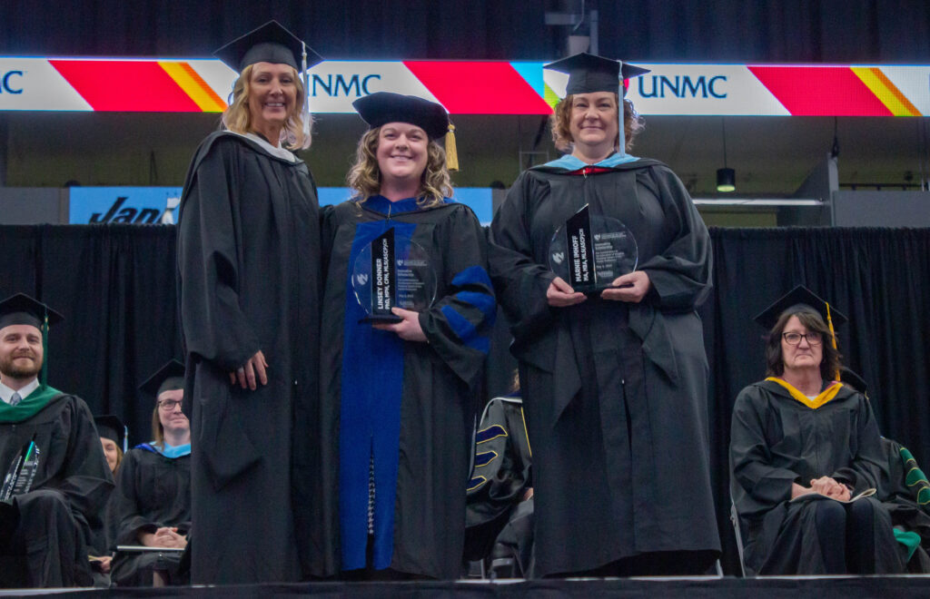 Kim Michael presents the Innovative Scholarship award to Linsey Donner, PhD, and Marnie Imhoff.