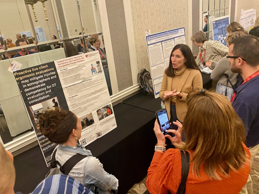 Dr. Smallfield presenting her poster to onlookers