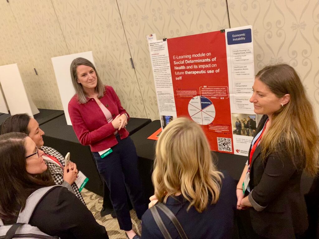 Dr. Stade presenting her poster to onlookers