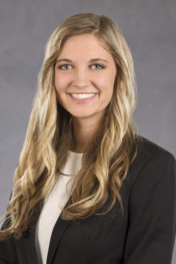 photo of Dr. Cichon smiling. her hair is long and blonde, and she is wearing a black blazer with a white blouse