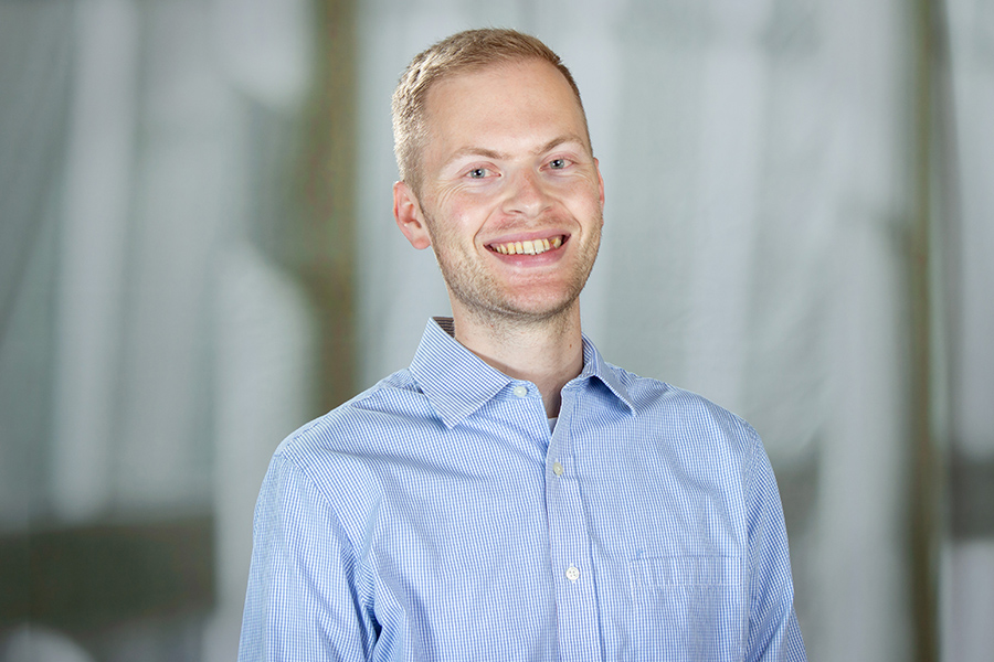 man wearing a blue shirt, smiling