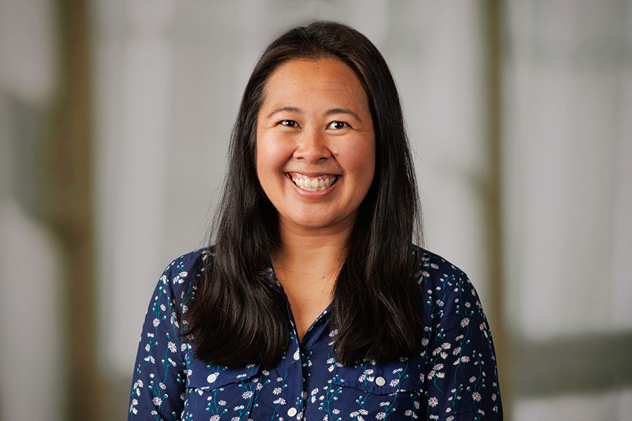 woman with long brown hair wearing a blue shirt