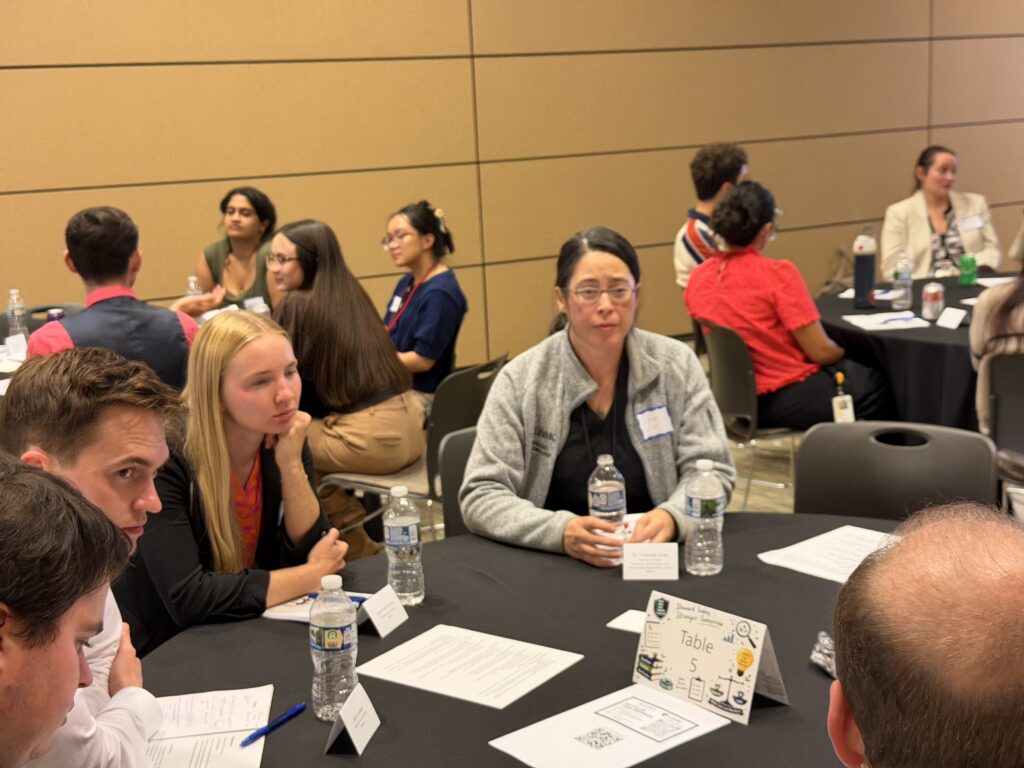 Conference attendees participate in a roundtable discussion during a professional development session