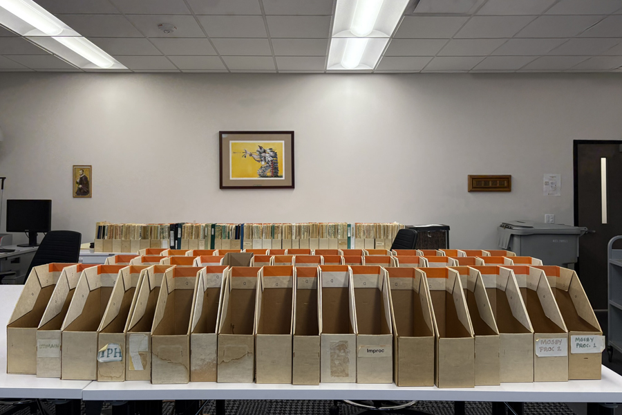 Empty magazine file folders spread out across a large archives table