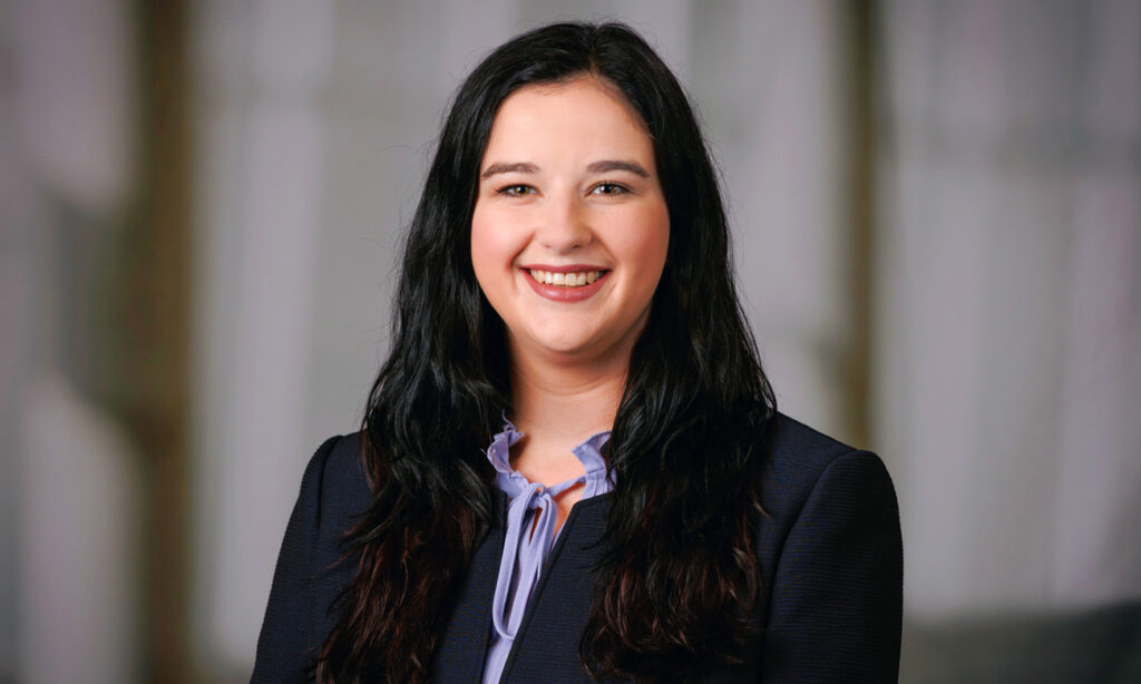 Image of Savanna in navy suite and light purple shirt