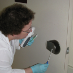 Above, a study nurse obtains an environmental study sample. 